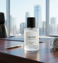 Bottle of 'SUCCESS' perfume on a desk with a cityscape view