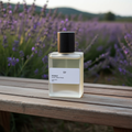 Perfume bottle on a wooden surface with lavender field in the background